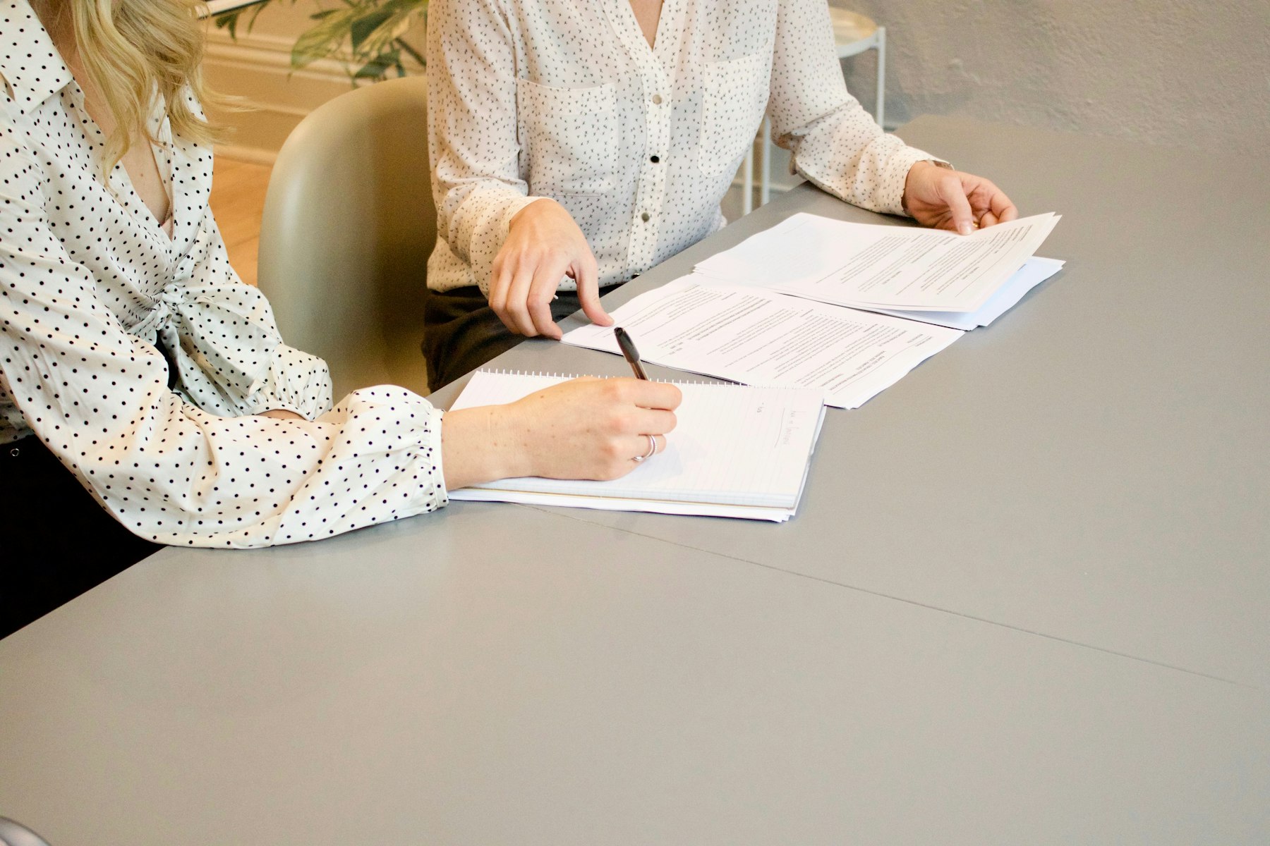 Two people reviewing business documents